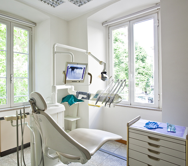 Clean dental treatment room with chair and equipment